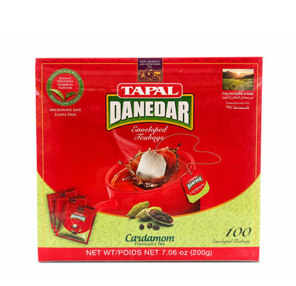 Tapal Danedar Cardamom Flavoured Tea box, red and green packaging with a teabag splashing into a cup and cardamom pods